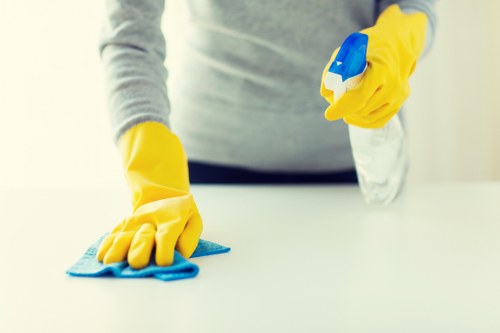Cleaner carrying equipment into a property for scheduled service